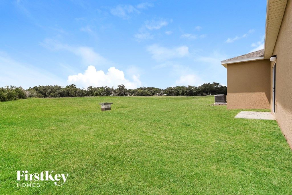 a large grassy field next to a house