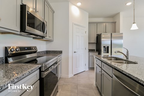 a kitchen with granite counter tops and stainless steel appliances