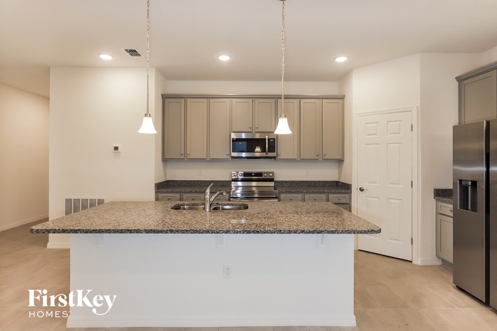 a kitchen with granite counter top and stainless steel appliances