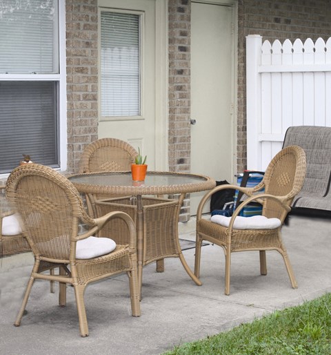 a patio with a table and chairs on a patio
