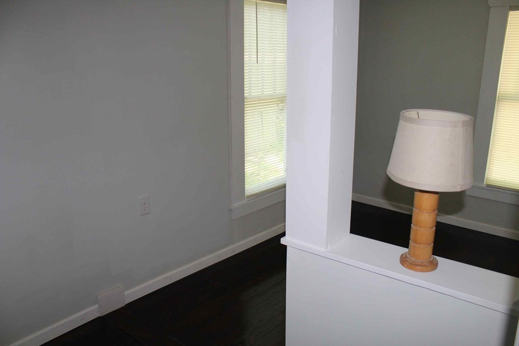 a lamp on a shelf in a room with white walls