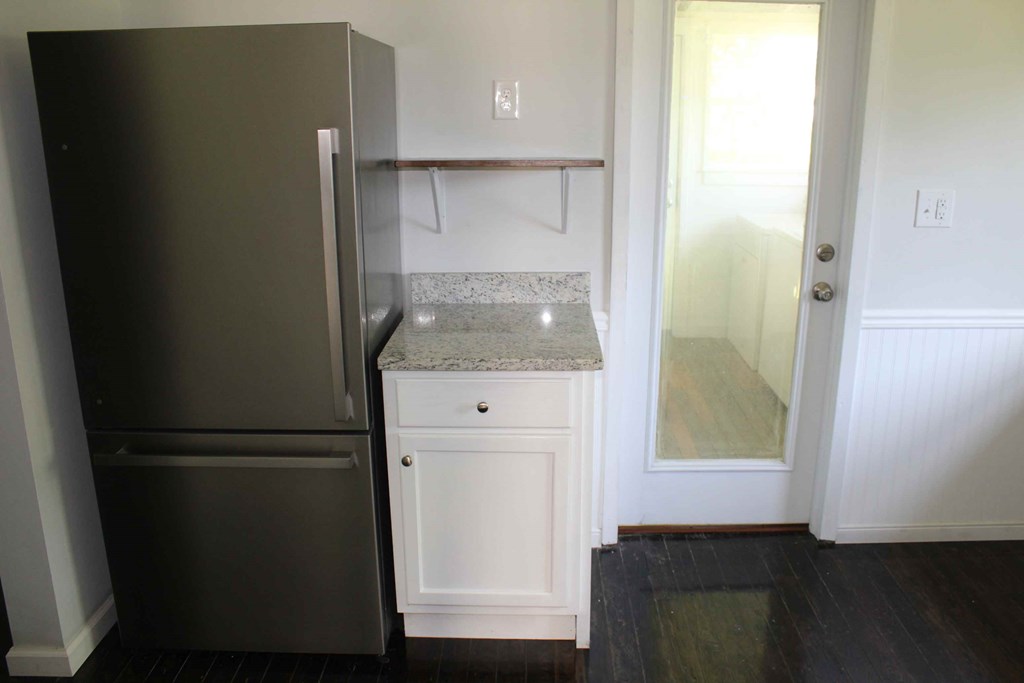 a small kitchen with a refrigerator and a sink