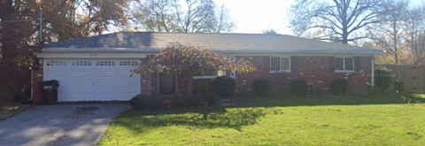 a red brick house with a white garage door