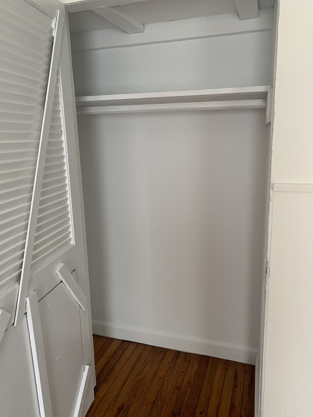 a small room with a closet and a ladder in it