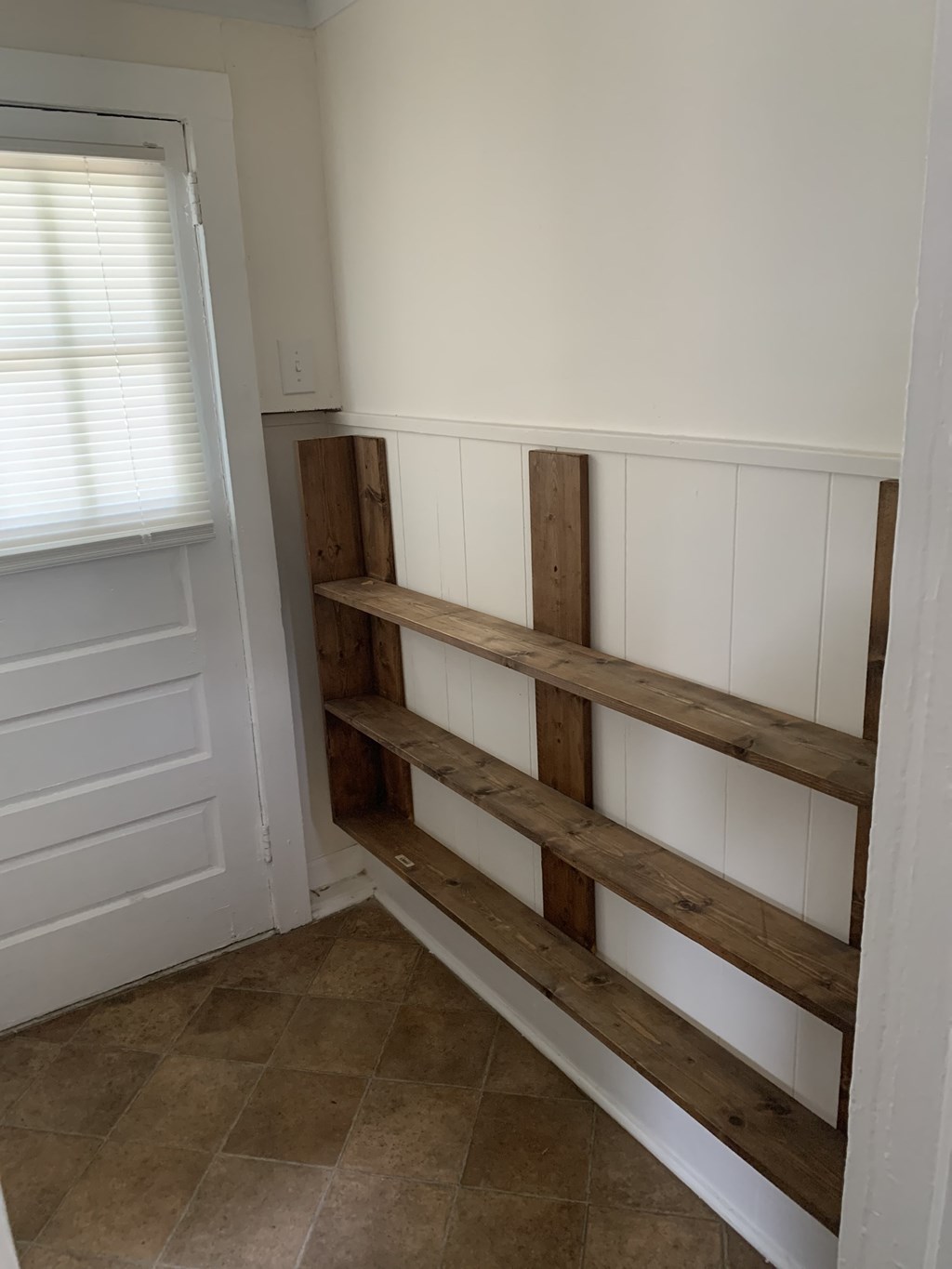 the shelf in the closet is made from reclaimed wood