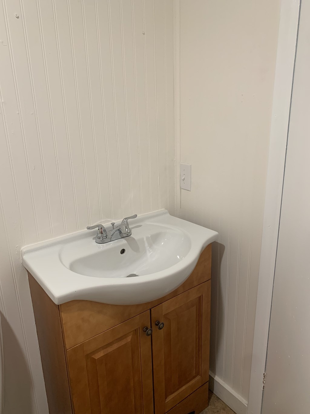 a sink in a bathroom with a wooden cabinet