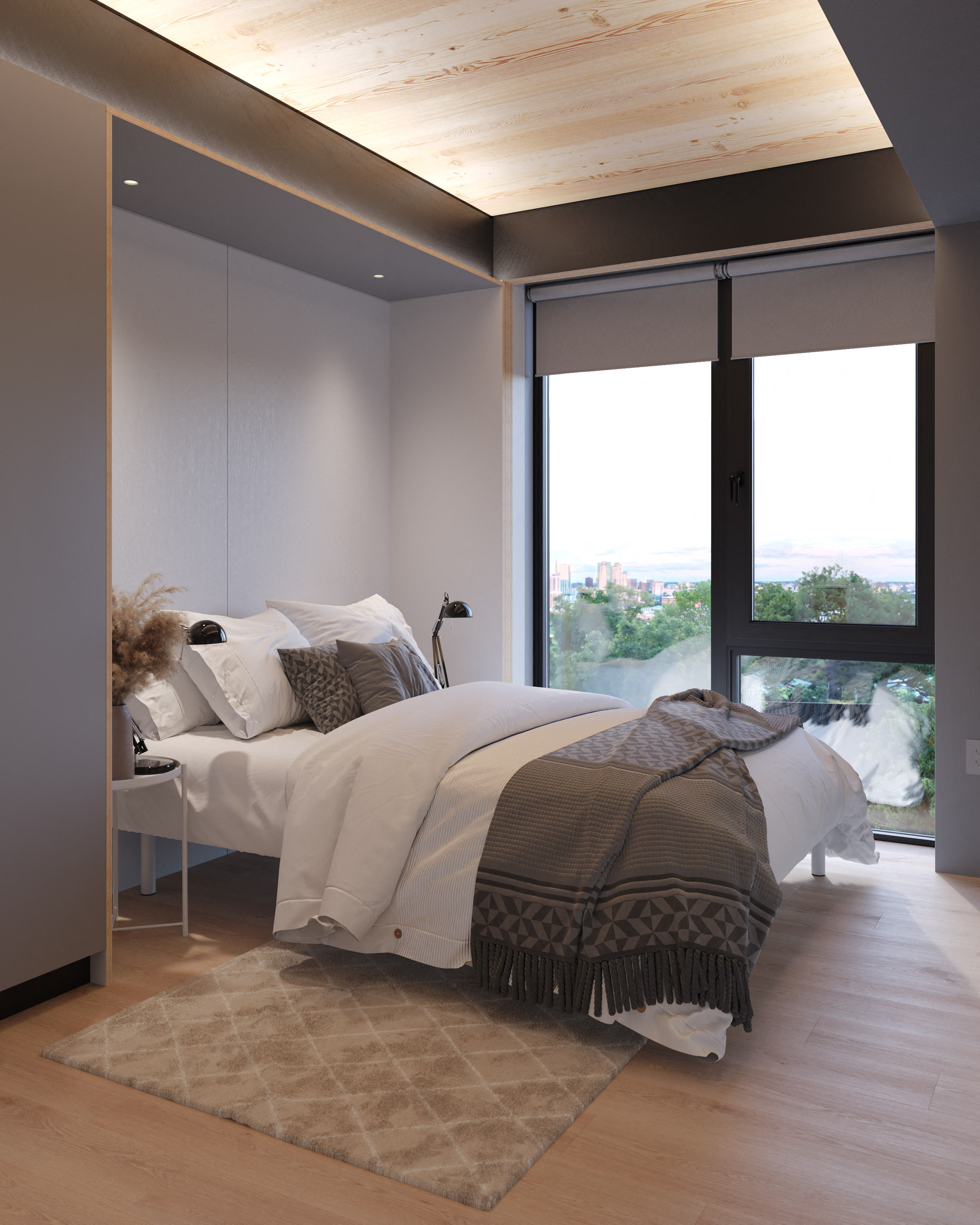 A bedroom with a bed covered in a white comforter and a grey blanket.