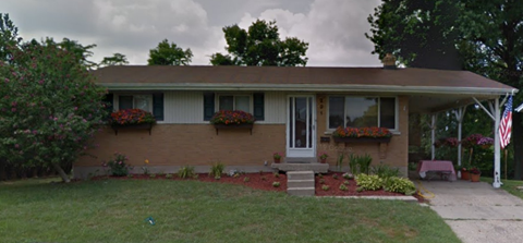 a house with an flag in the front yard