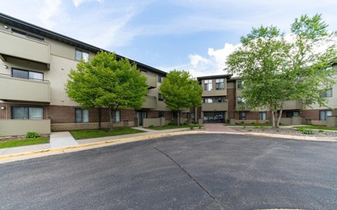 an empty street in front of an apartment building