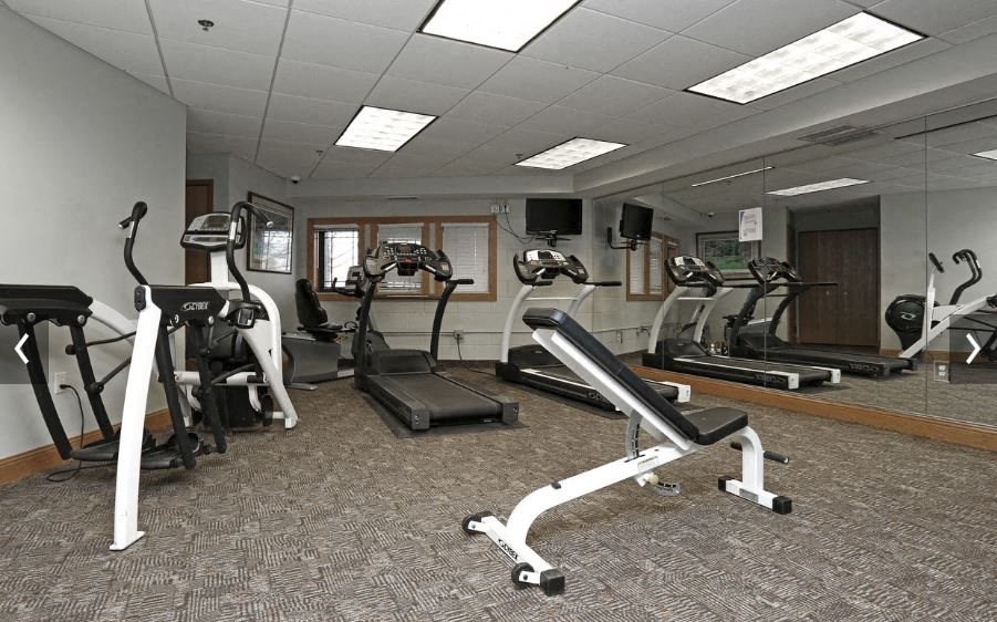 a gym with various exercise equipment in it