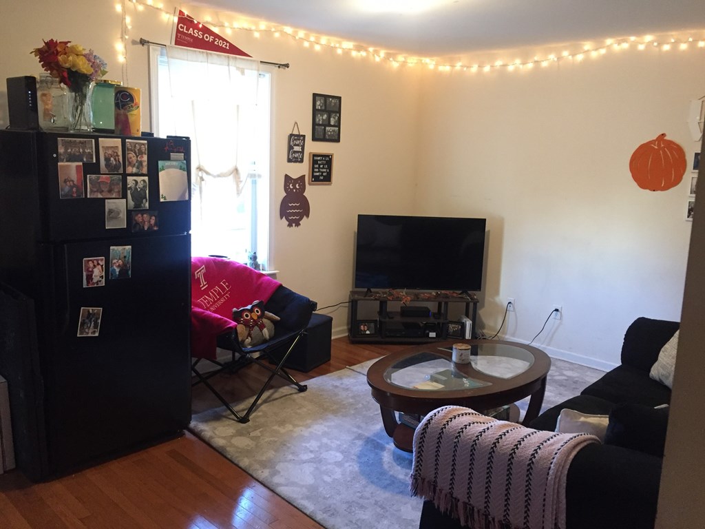 a living room with a tv and a couch and a table