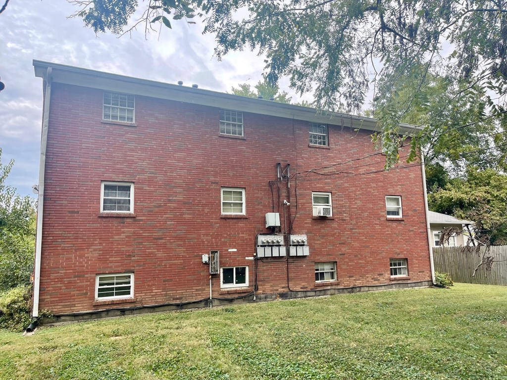A red brick building with white trim and multiple windows.