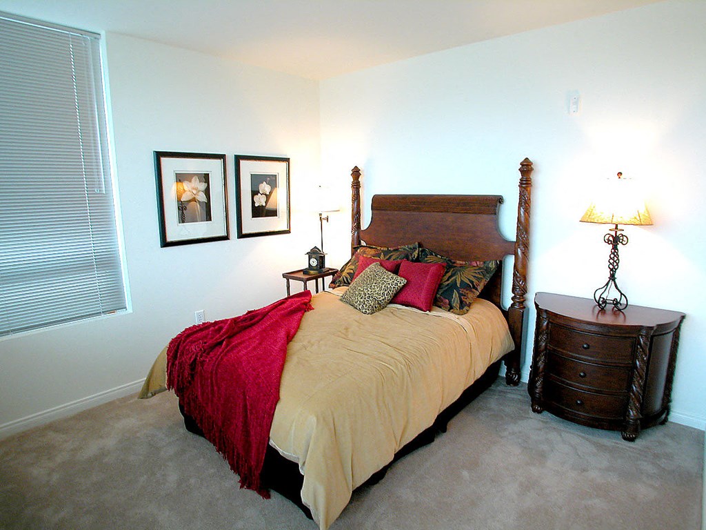a bedroom with a bed and a dresser