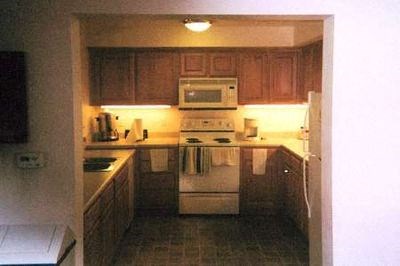 a small kitchen with a stove and a microwave