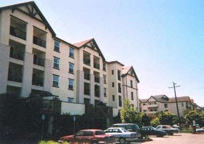 an apartment building with cars parked in front of it