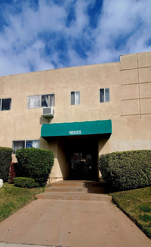 an office building with a green awning on the front of it