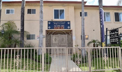 a white building with a gate in front of it