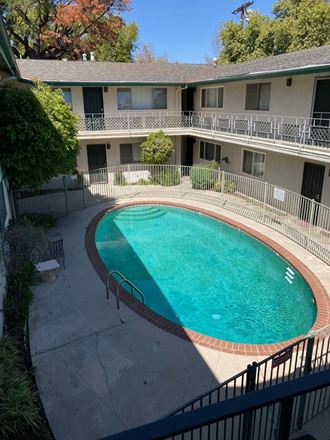 a large pool in front of an apartment building