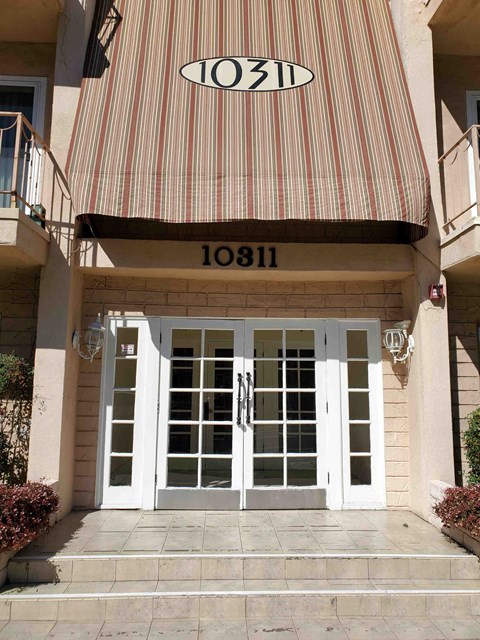 a striped awning over the front door of a building