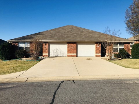 A house with a brown roof and a white garage door.