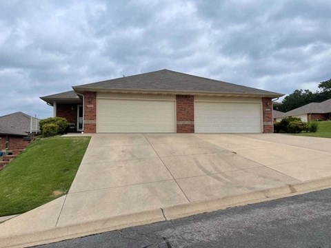 A house with a grey roof and a grey garage door.