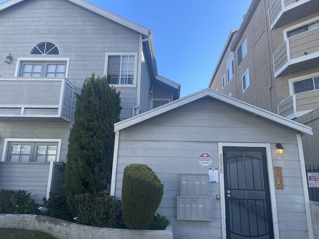 a white house with a street sign on the side of it