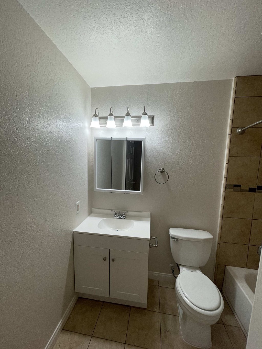 a bathroom with a toilet and a sink and a mirror