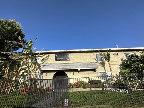 an old building with a fence and a sign on it