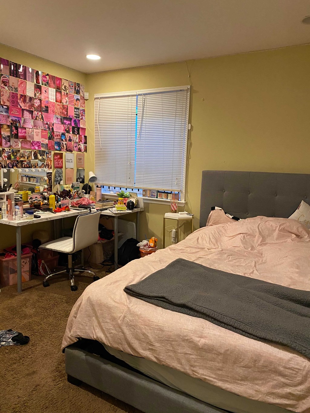 a bedroom with a bed and a desk and a window