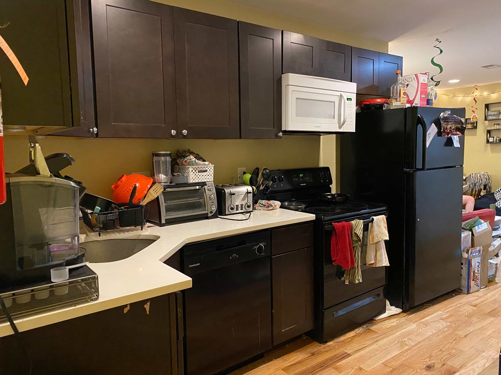 a kitchen with black appliances and white counter tops