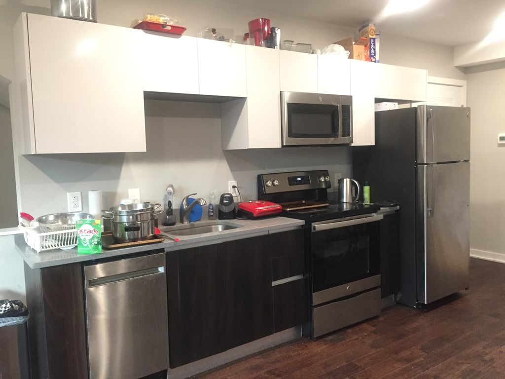 a kitchen with stainless steel appliances and a sink and refrigerator