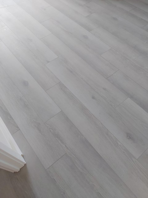 a close up of a wooden floor with a book on it