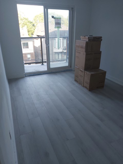a room with boxes on the floor and a sliding glass door