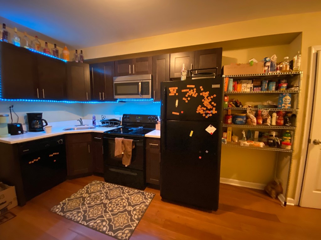 a kitchen with black appliances and a black refrigerator