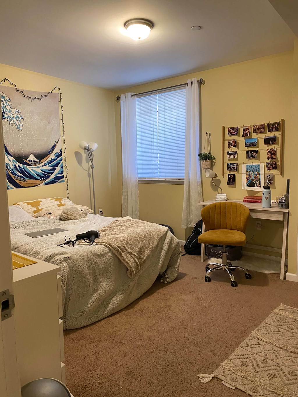 a bedroom with a bed and a desk and a chair