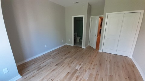 a newly renovated living room with wood flooring