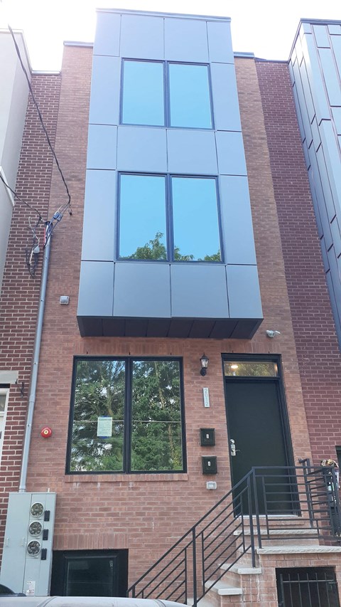 the front of a brick building with blue windows