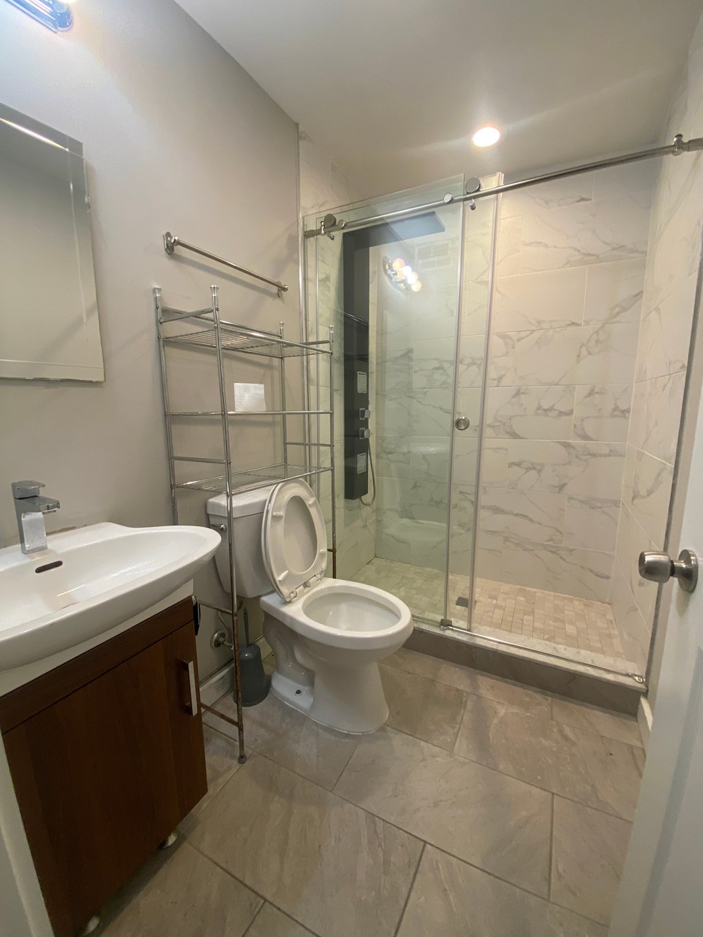 a bathroom with a shower and a toilet and a sink