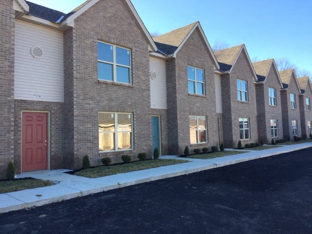 a row of brick houses with a red door