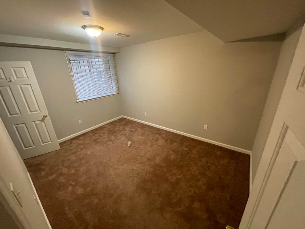 a empty room with a door and a window