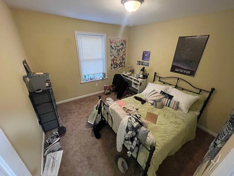 a bedroom with a bed and a desk