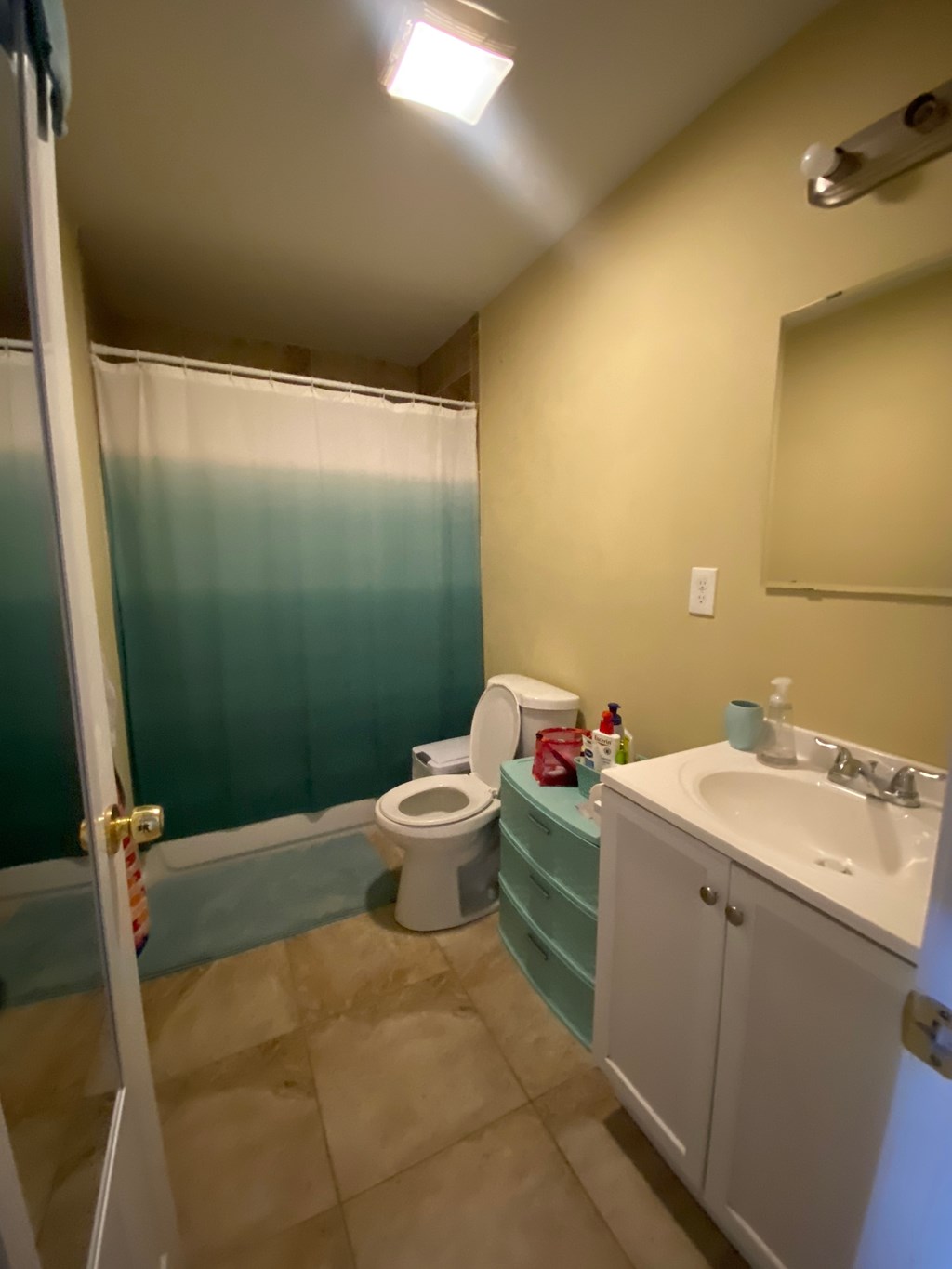 a bathroom with a toilet and a sink and a shower