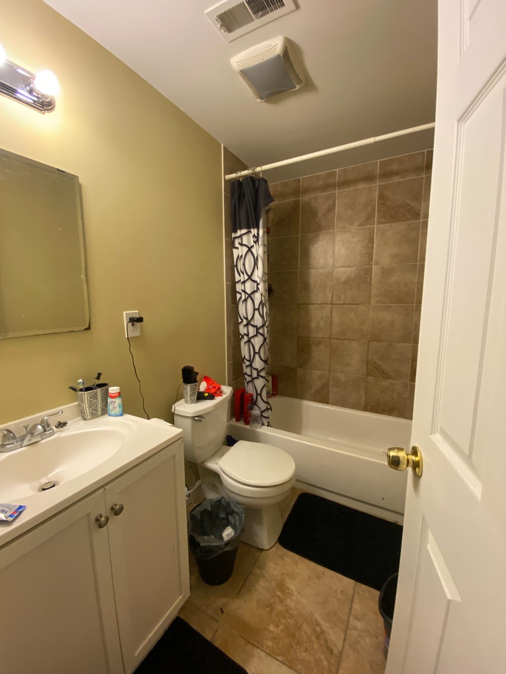 a bathroom with a toilet and a tub and a sink