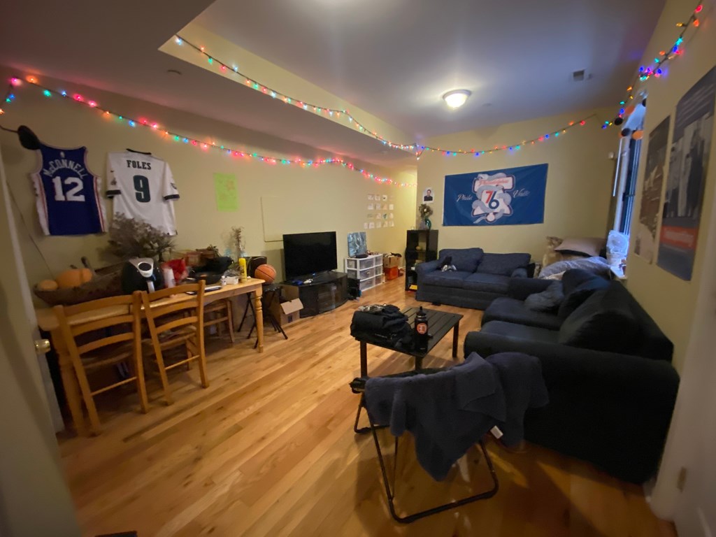 the living room and dining room are decorated with christmas lights