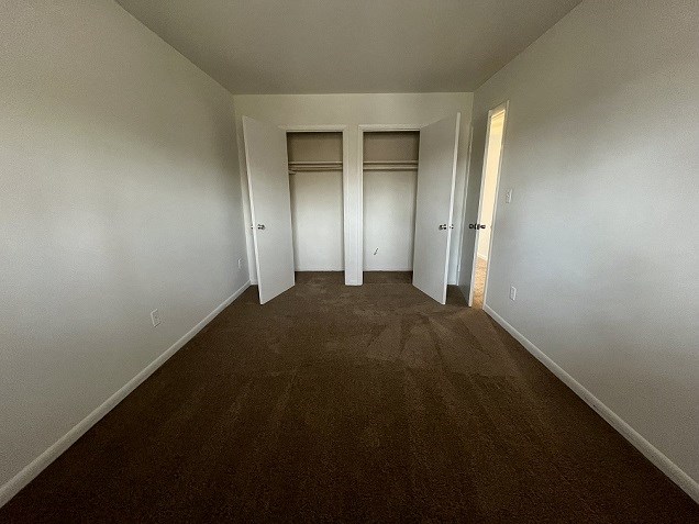 a empty room with a wooden floor and white walls
