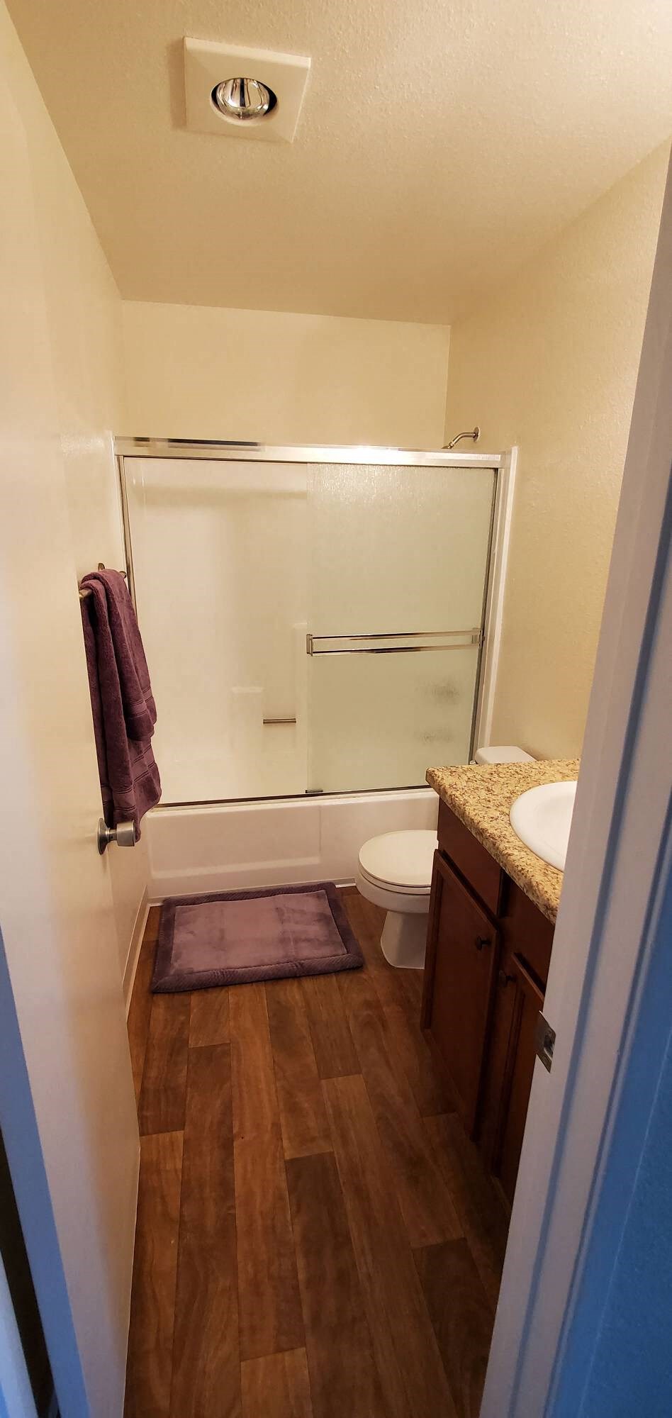 a bathroom with a toilet and a shower