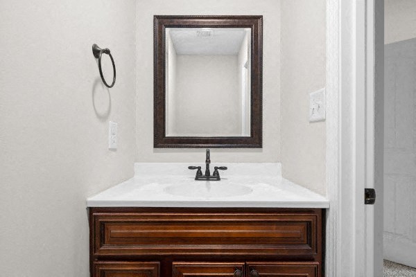 a bathroom with a white sink and a mirror