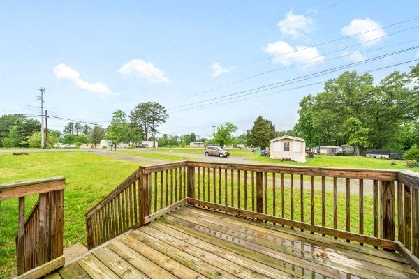 the view from the deck of a house with a wooden railing