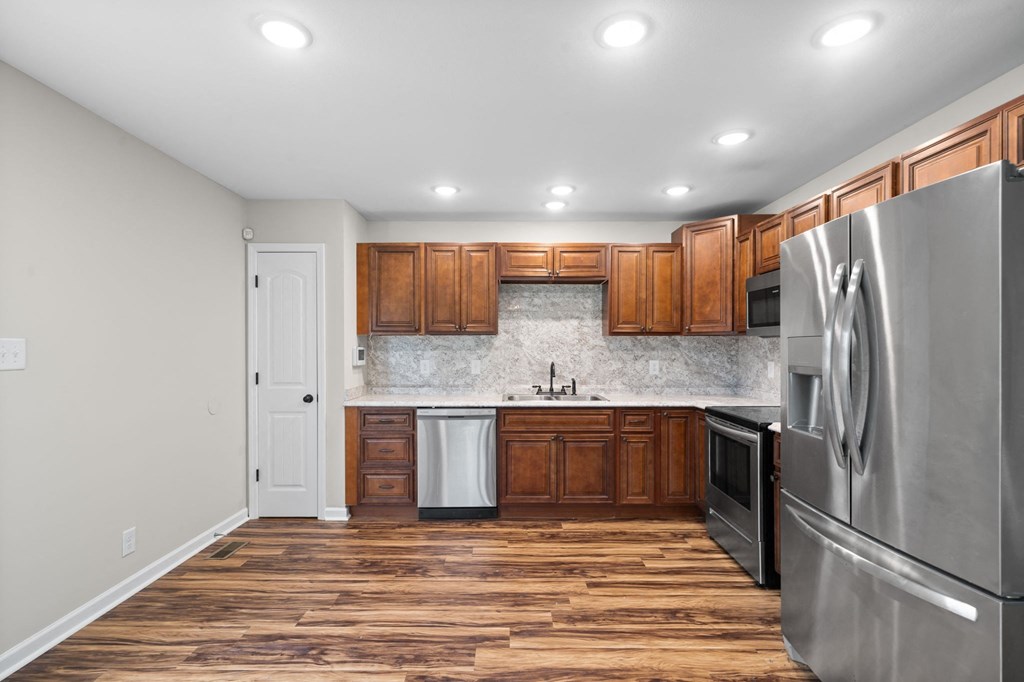 a kitchen with stainless steel appliances and wooden cabinets
