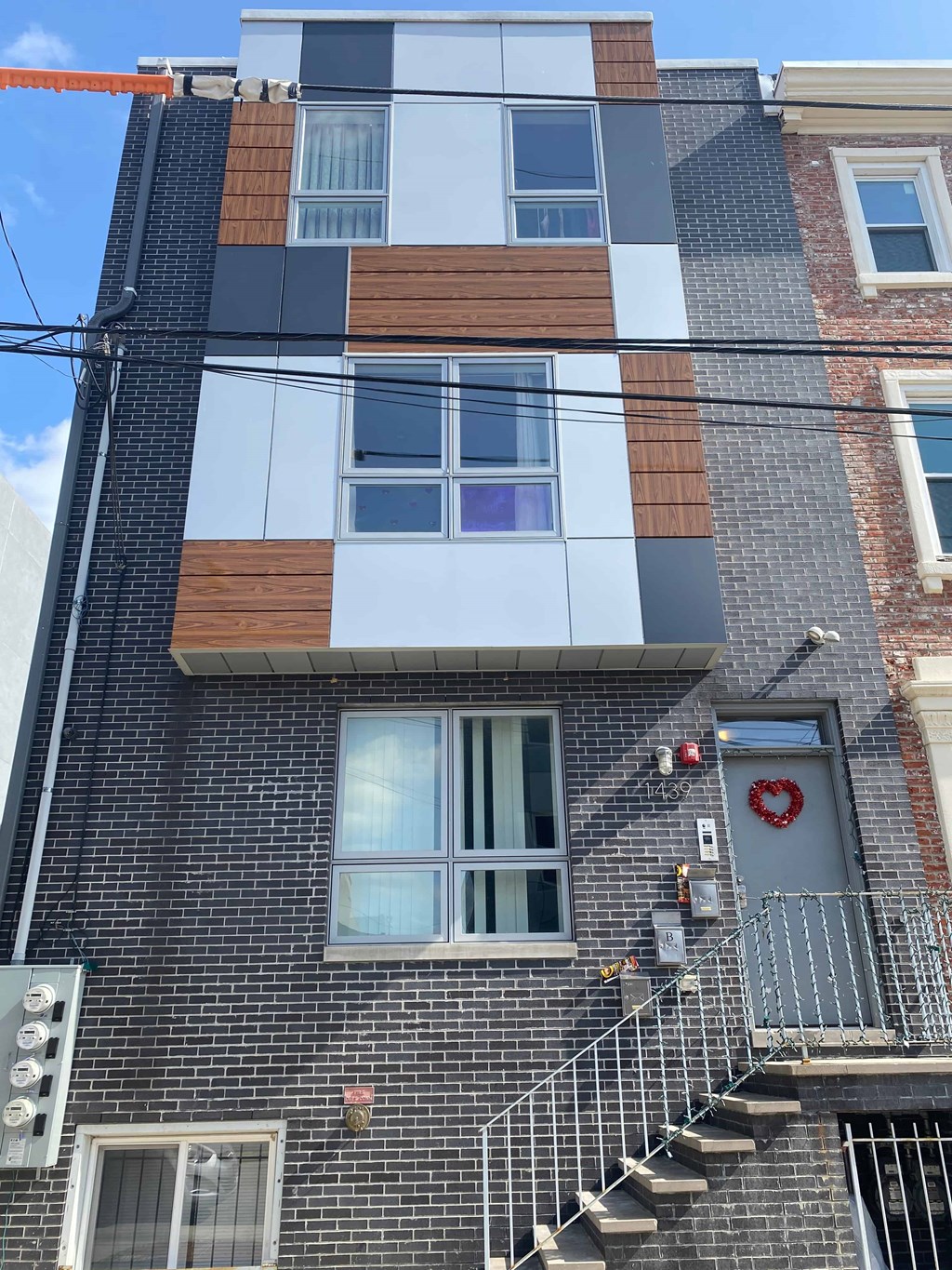 the front of a brick building with stairs and a window